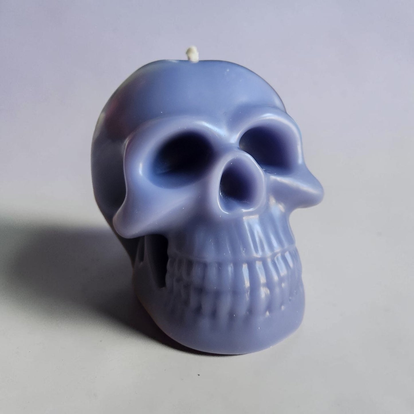 Soft Indigo Gloomy Grin Skull Candle